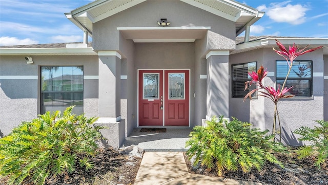 entrance to property featuring stucco siding