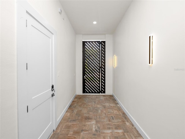 hall featuring baseboards and recessed lighting