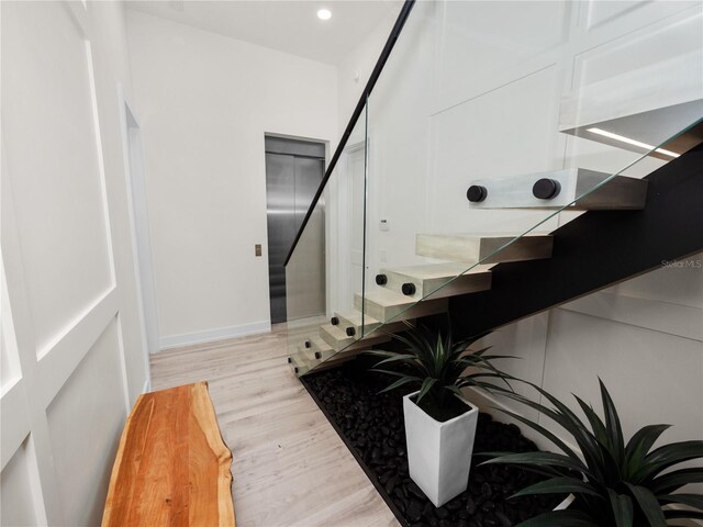 bathroom with recessed lighting, baseboards, and wood finished floors