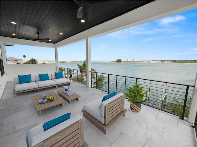 view of patio featuring a water view, ceiling fan, and an outdoor hangout area