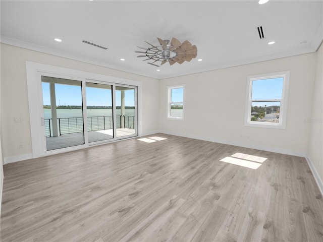 empty room with recessed lighting, plenty of natural light, and light wood-style flooring
