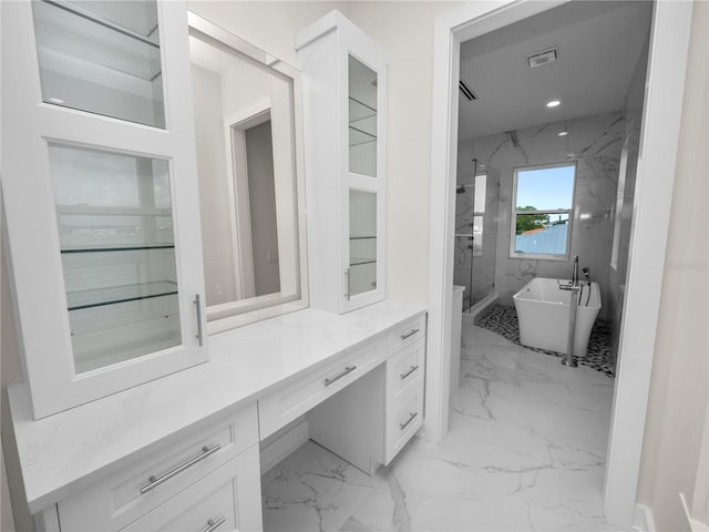 interior space with a marble finish shower, a soaking tub, marble finish floor, vanity, and recessed lighting