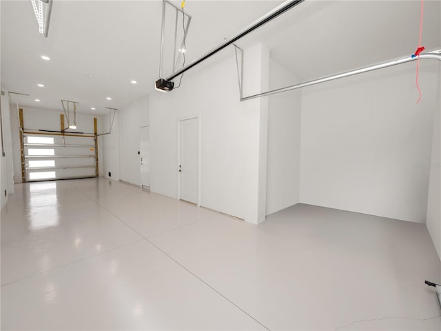 garage with recessed lighting and a garage door opener
