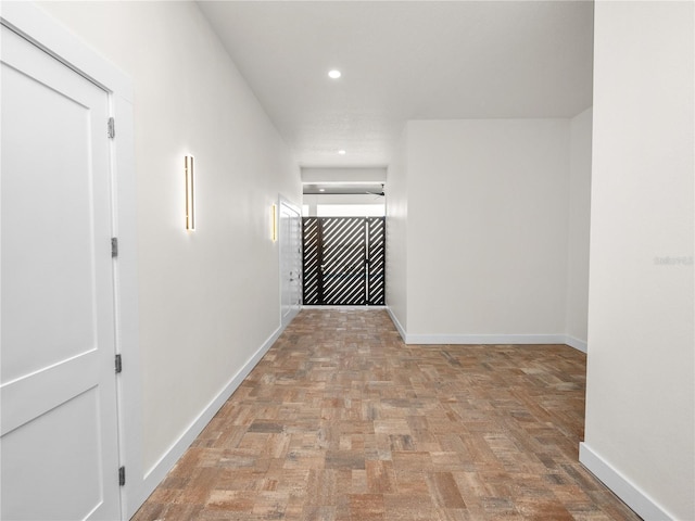 corridor featuring recessed lighting and baseboards