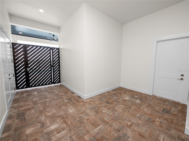 spare room with a ceiling fan, recessed lighting, and baseboards