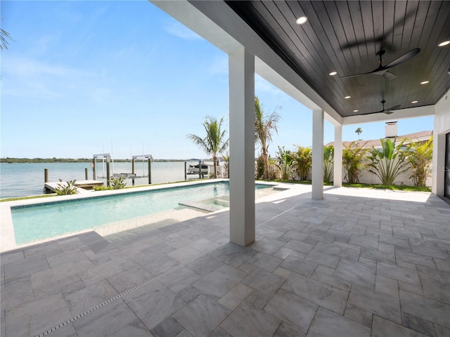 outdoor pool featuring boat lift, a water view, a ceiling fan, a patio area, and a dock