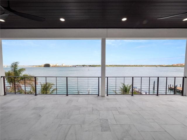 view of patio / terrace with a water view and a balcony