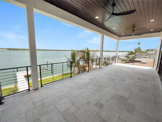 view of patio / terrace featuring a water view and ceiling fan