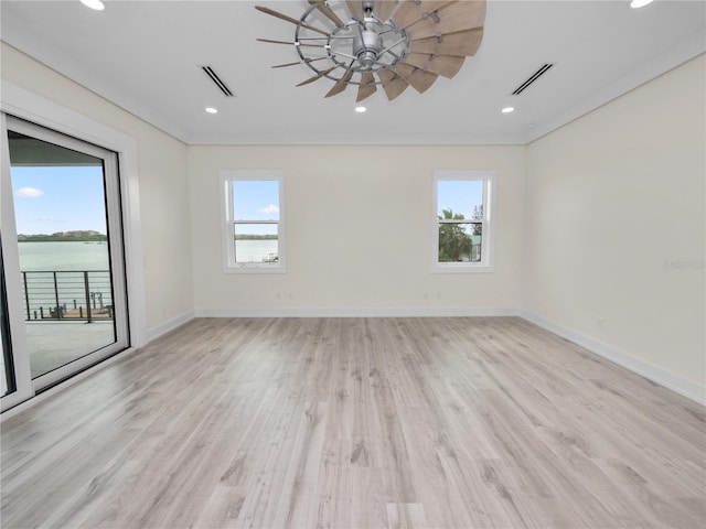 empty room with plenty of natural light, visible vents, and baseboards