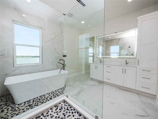 full bathroom with marble finish floor, double vanity, recessed lighting, visible vents, and a freestanding bath