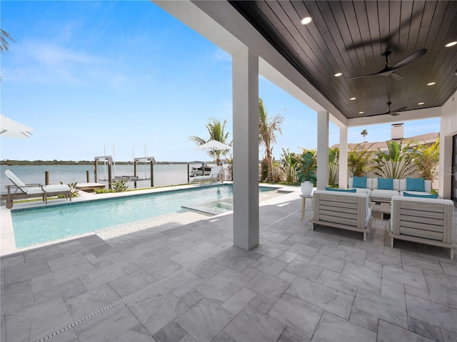 pool with a ceiling fan, a patio, boat lift, a dock, and an outdoor living space