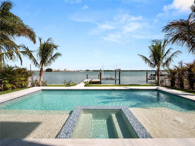 view of pool featuring a pool with connected hot tub, a water view, a boat dock, and boat lift