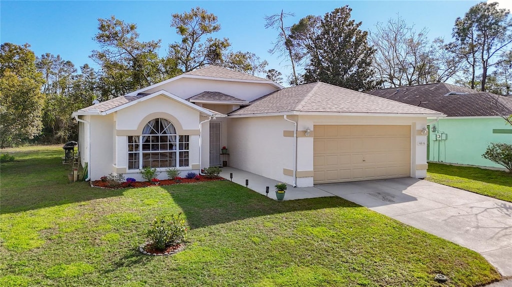 ranch-style home with an attached garage, concrete driveway, roof with shingles, stucco siding, and a front yard