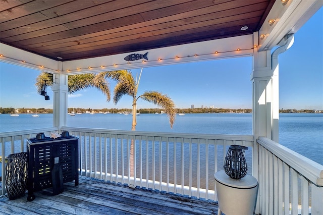 wooden terrace featuring a water view