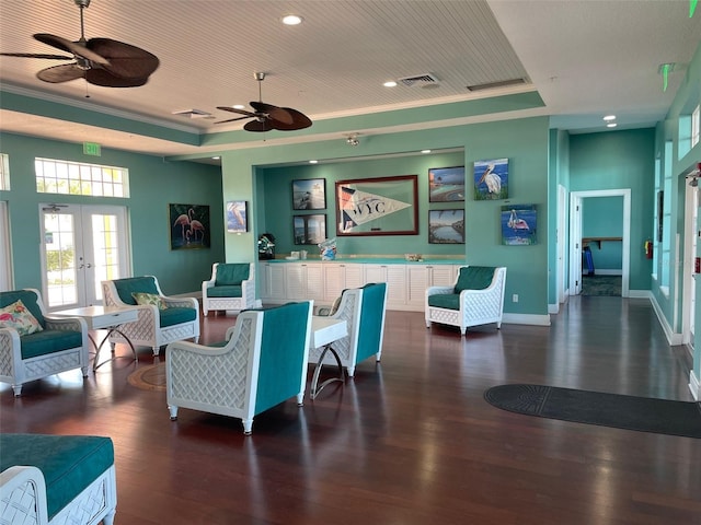 living room with visible vents, a raised ceiling, french doors, wood-type flooring, and baseboards