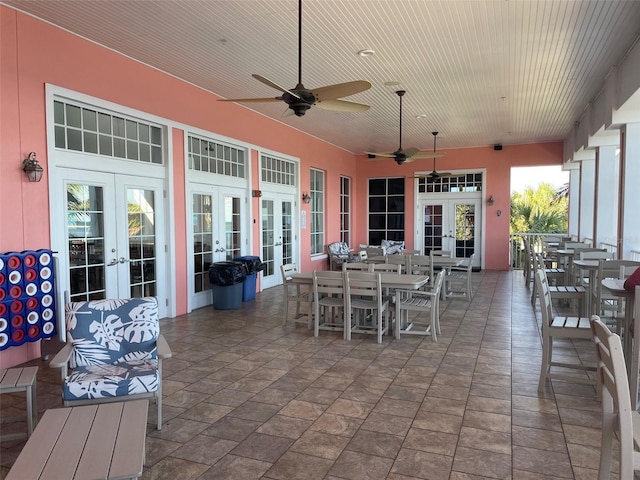 view of patio with outdoor dining space, french doors, and a ceiling fan