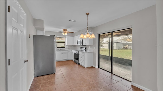 kitchen featuring light tile patterned floors, stainless steel appliances, light countertops, visible vents, and white cabinetry