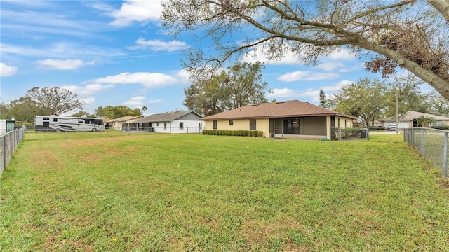 view of yard with a sunroom and a fenced backyard