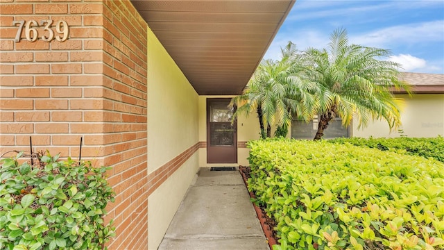 doorway to property with brick siding