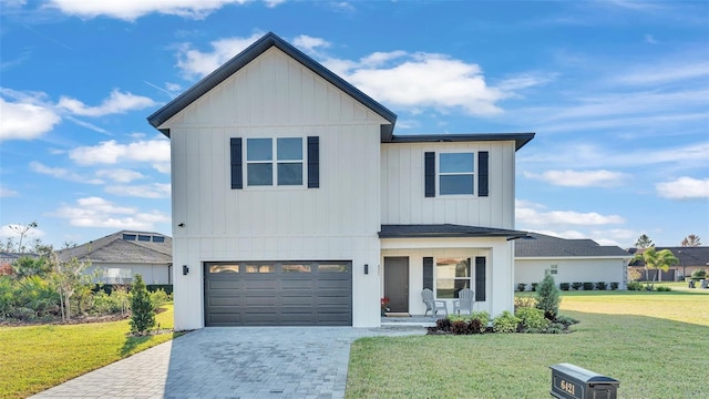 modern farmhouse style home with a porch, an attached garage, decorative driveway, board and batten siding, and a front yard