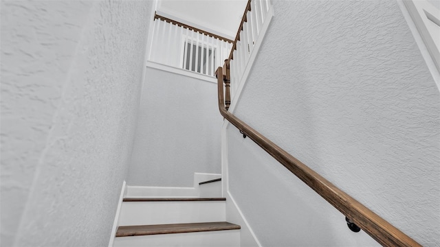 staircase with a textured wall