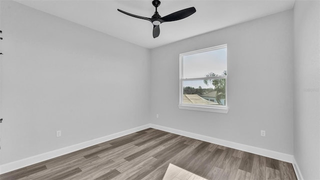 spare room with a ceiling fan, baseboards, and wood finished floors