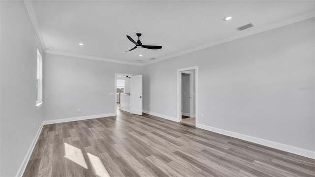 unfurnished bedroom with baseboards, visible vents, ornamental molding, wood finished floors, and recessed lighting