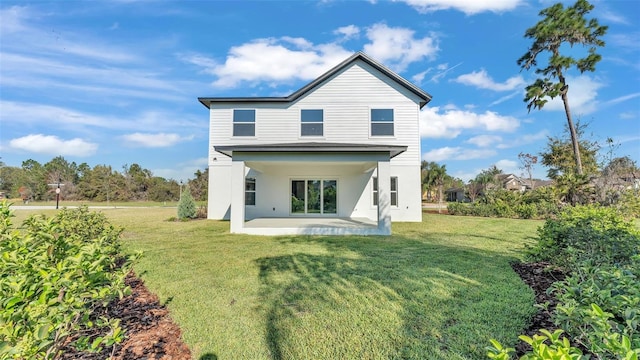 back of property featuring a lawn and a patio area