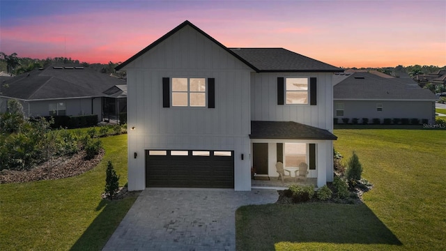 modern farmhouse style home featuring an attached garage, roof with shingles, decorative driveway, a front lawn, and board and batten siding