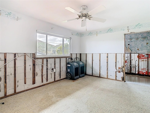 unfurnished room with a ceiling fan and speckled floor