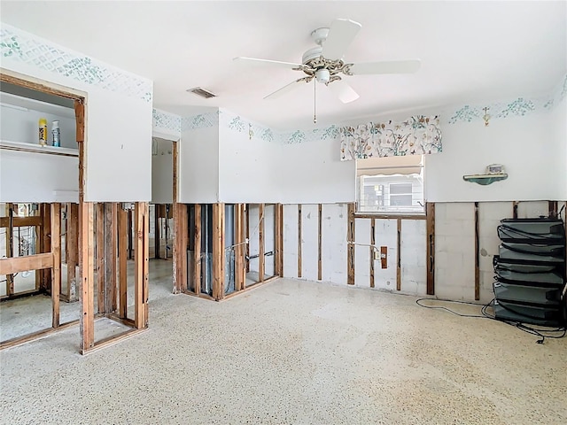 misc room featuring speckled floor, visible vents, and ceiling fan