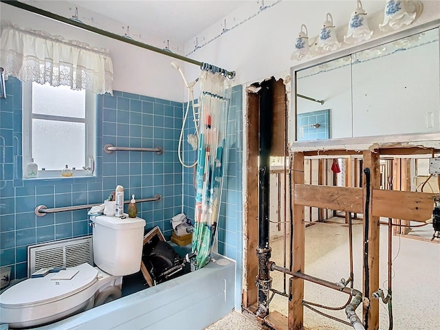 bathroom with speckled floor, toilet, tile walls, and shower / tub combo with curtain