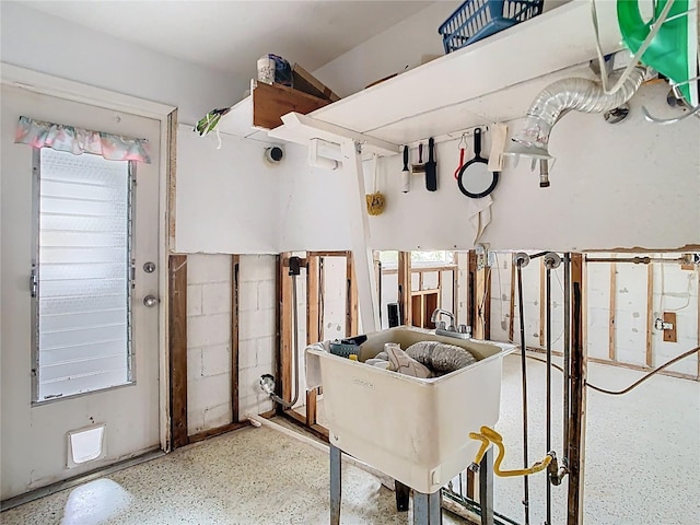 misc room with speckled floor and a sink