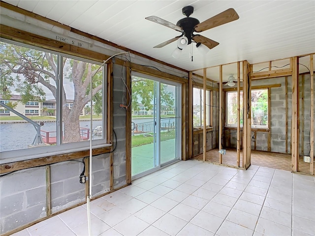 unfurnished sunroom with plenty of natural light and ceiling fan