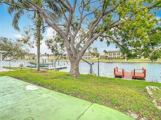 view of yard featuring a dock and a water view