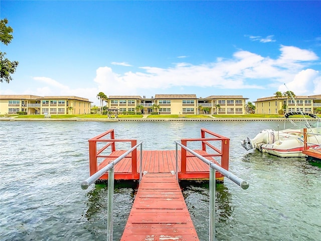 dock area featuring a water view and a residential view