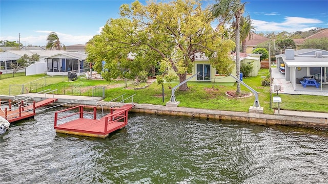 dock area featuring a yard, a water view, and a residential view