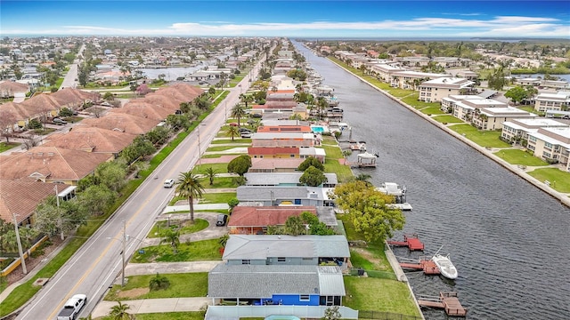 drone / aerial view with a residential view and a water view