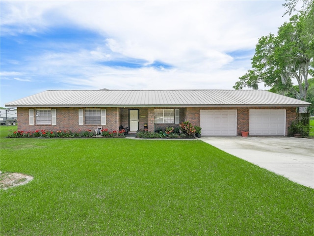 single story home with a garage, concrete driveway, a front lawn, and brick siding