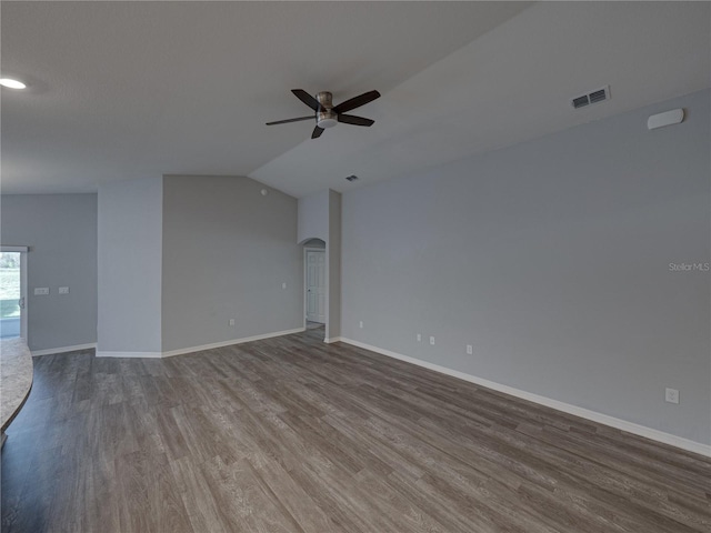 unfurnished living room featuring a ceiling fan, wood finished floors, visible vents, baseboards, and arched walkways