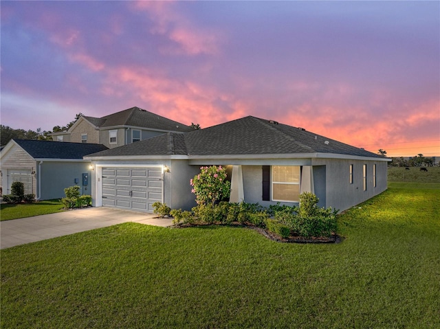 view of front of house with stucco siding, a front lawn, driveway, a shingled roof, and a garage