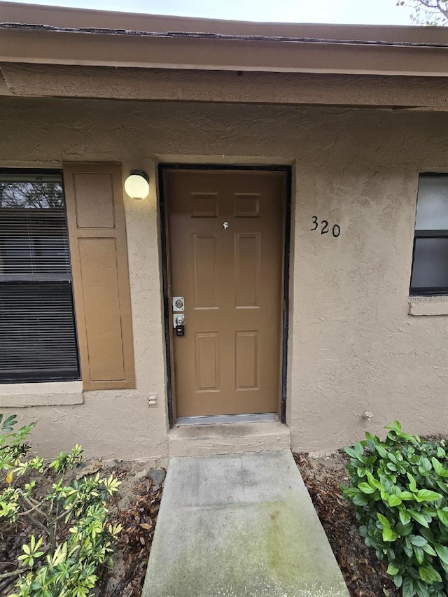 property entrance featuring stucco siding