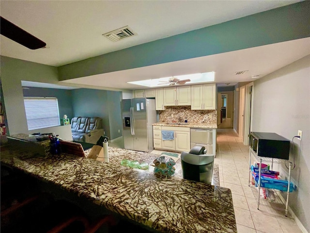 kitchen with light tile patterned floors, visible vents, a ceiling fan, appliances with stainless steel finishes, and backsplash