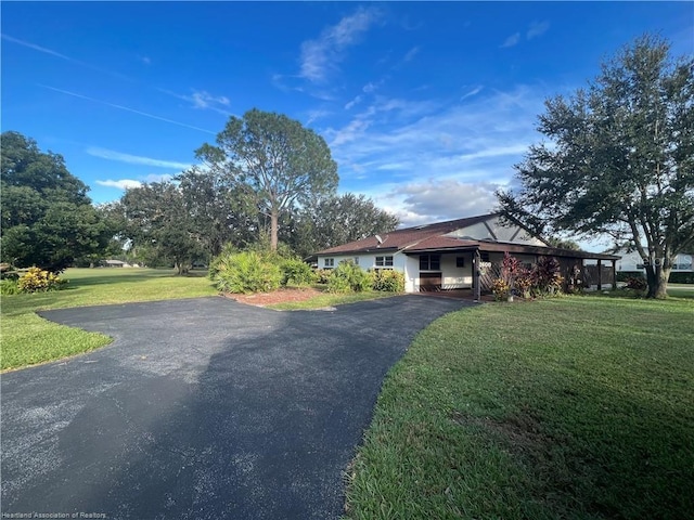 exterior space with driveway and a front lawn