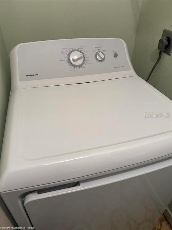 clothes washing area featuring laundry area and washer / clothes dryer