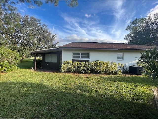 view of home's exterior with a lawn, cooling unit, and stucco siding