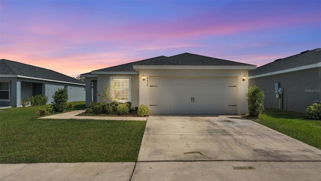 single story home with a garage, a front yard, concrete driveway, and stucco siding