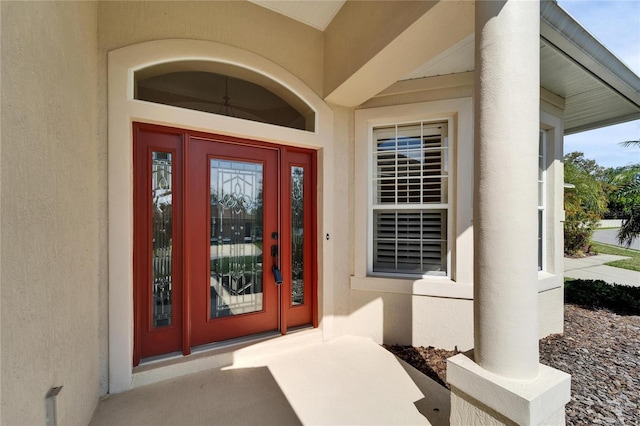 entrance to property with stucco siding