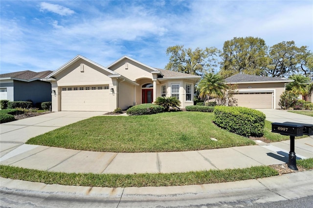 ranch-style house featuring an attached garage, a front yard, concrete driveway, and stucco siding