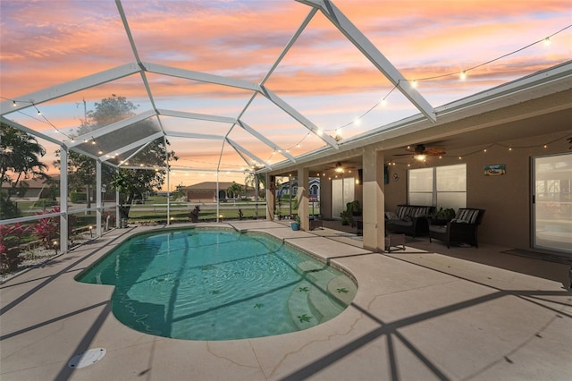 outdoor pool featuring a lanai, a patio area, ceiling fan, and an outdoor living space